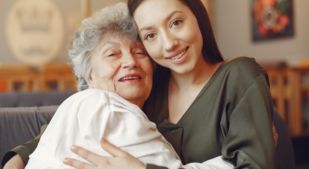 Old woman in a cafe with young granddaughter